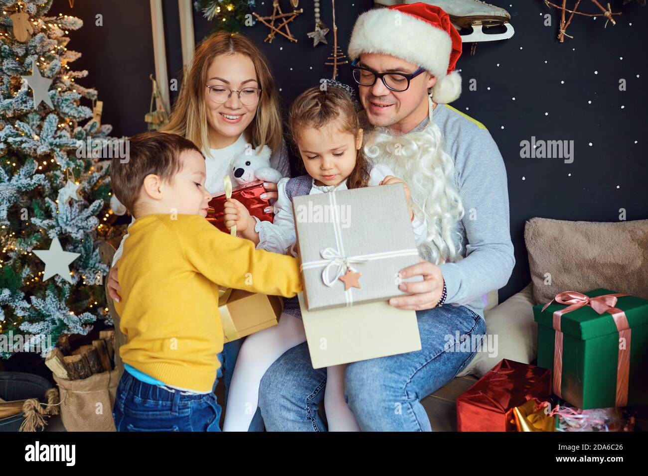 Happy family opening Christmas gifts Stock Photo