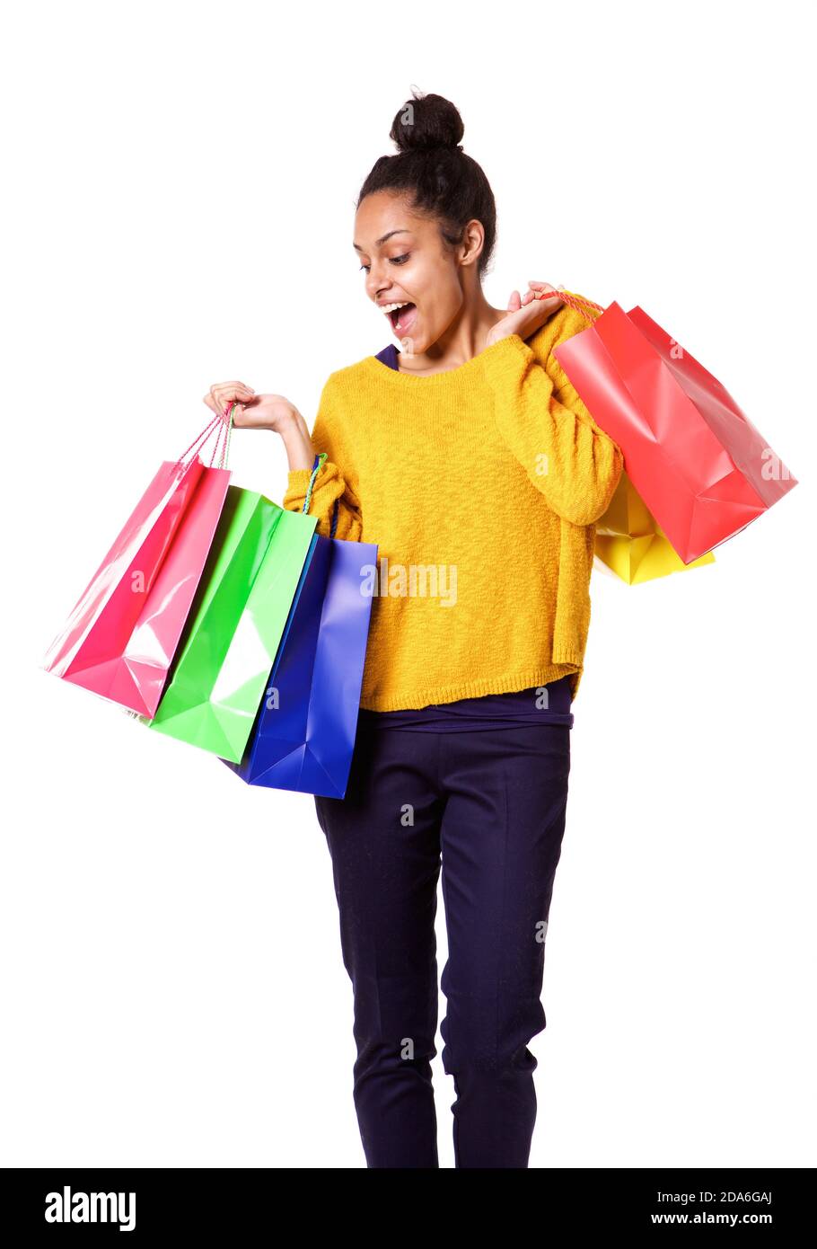 Portrait of young smiling black woman holding colorful shopping bags on ...