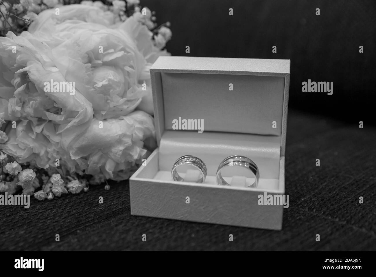 Wedding rings in a box next to a bouquet made of white roses Stock ...