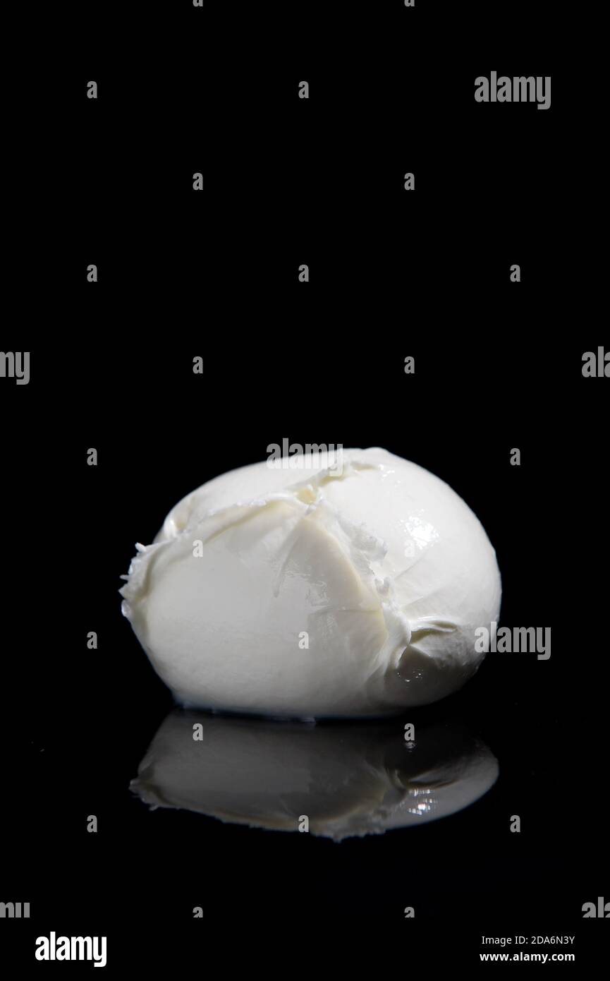 mozzarella cheese from Campania region Italy on a black mirrored