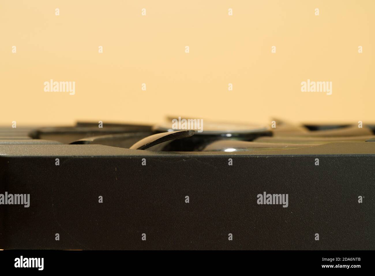 side view of video card with cooler on peach colored background Stock Photo
