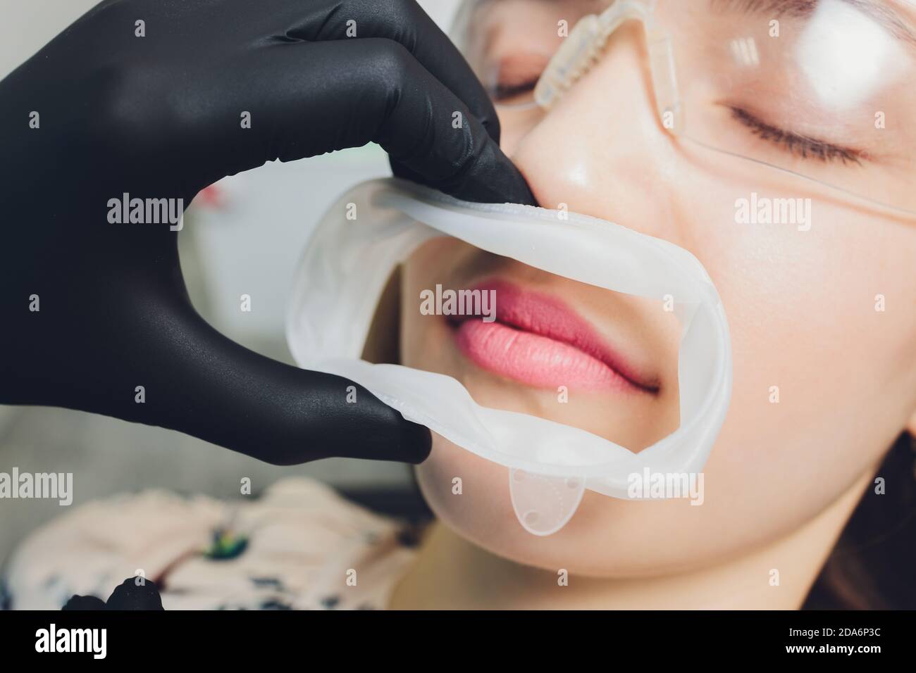 Close-up photo of a disposable dental rubber dam used for keeping soft tissues of mouth safe from dental tools. Stock Photo