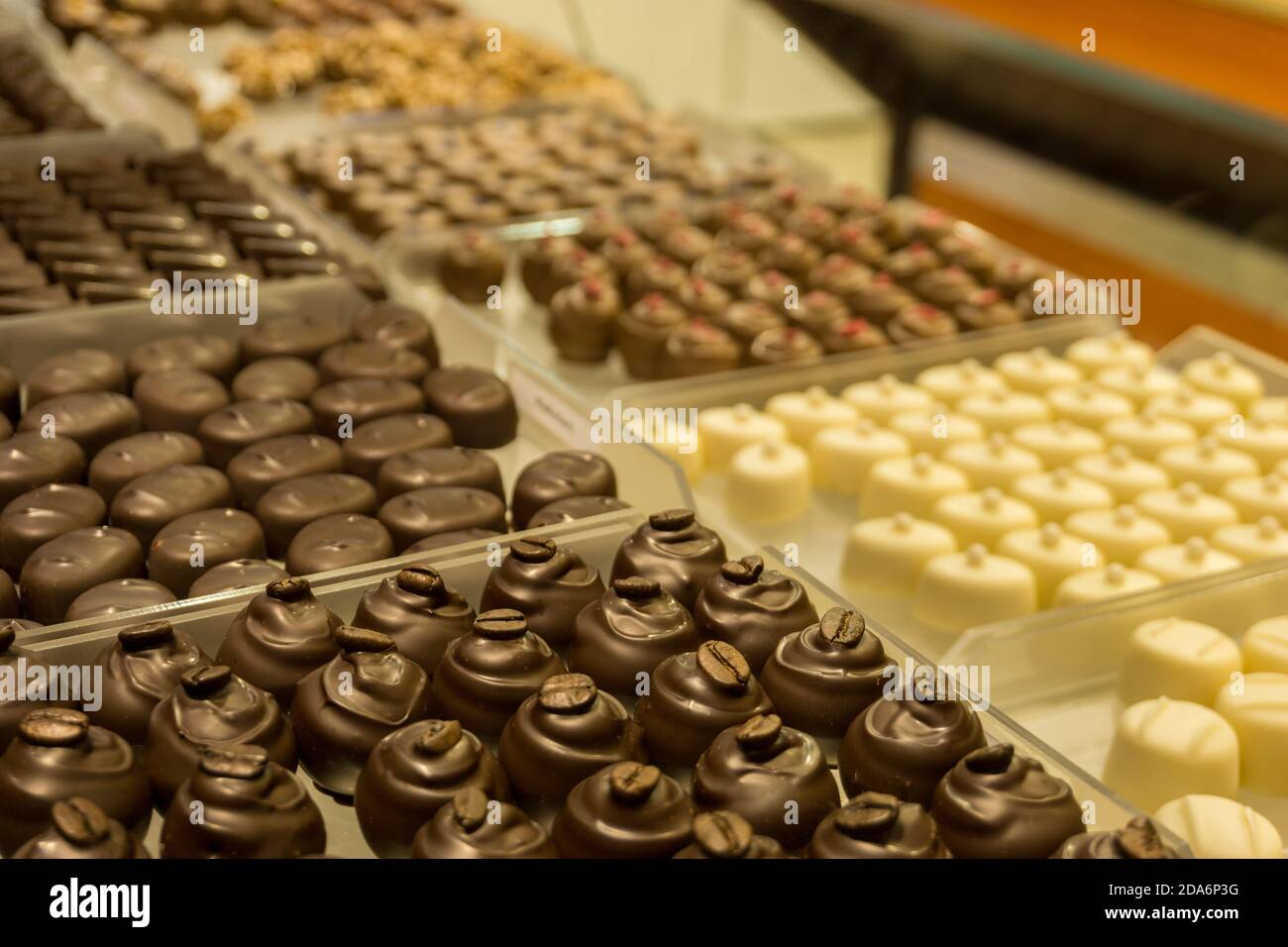 Patern of many different chocolate pralines in showcase at store Stock Photo