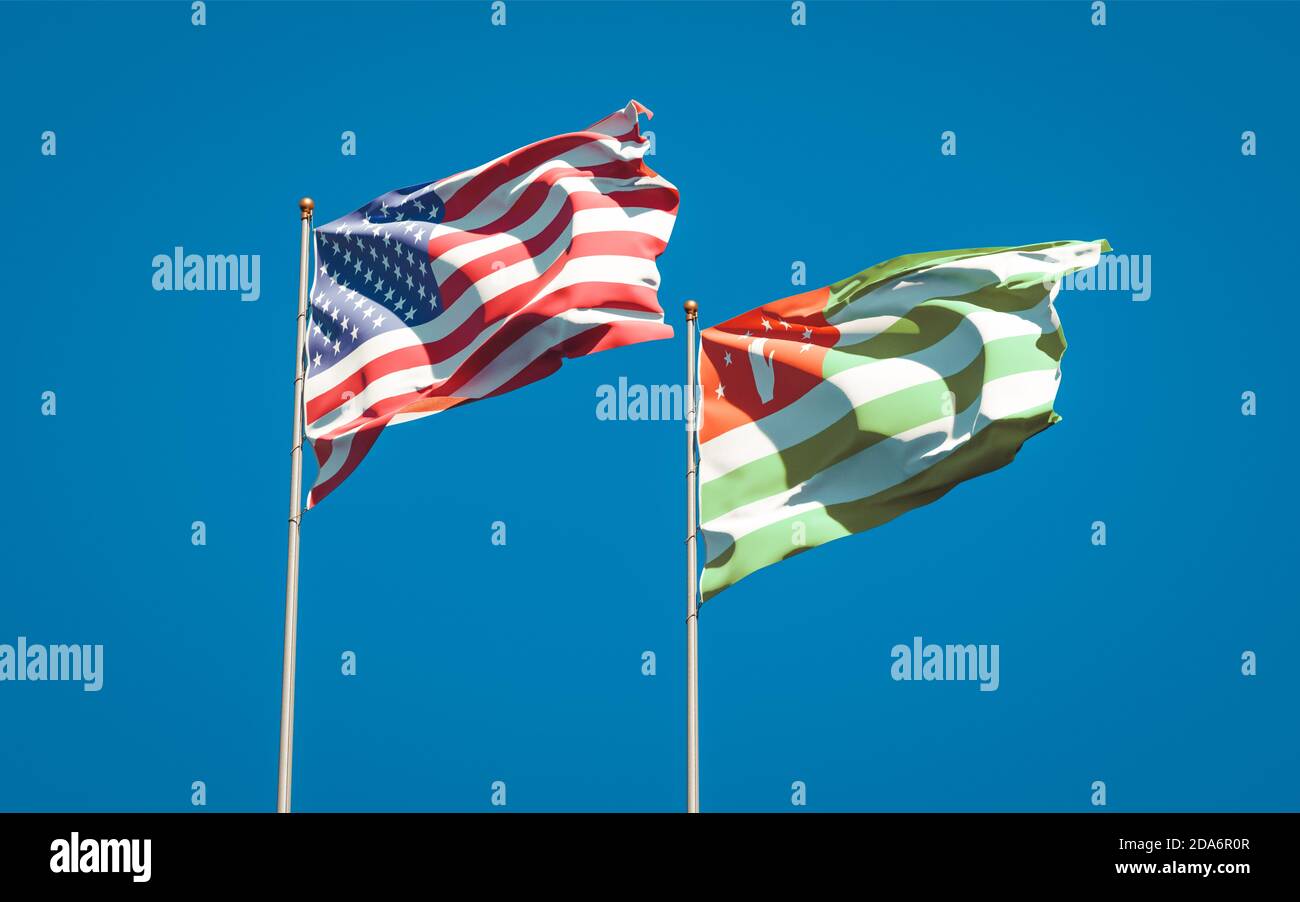 Beautiful national state flags of USA and Abkhazia together at the sky ...