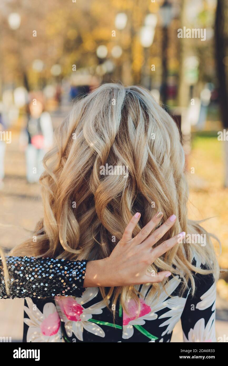Portrait of a beautiful young woman with long blonde hair enjoying ...