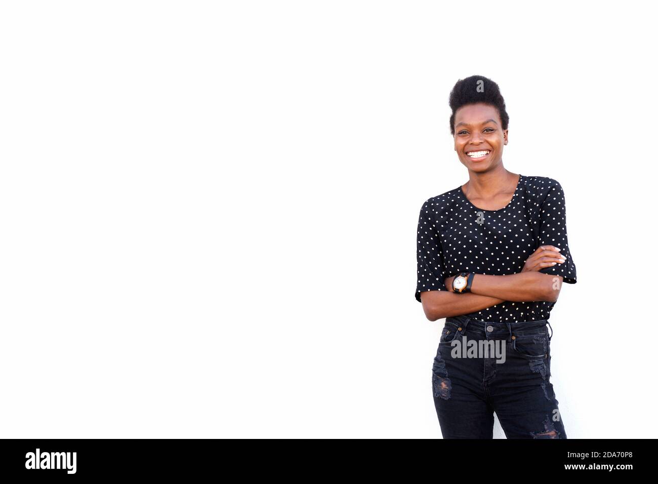 Portrait of beautiful young african woman standing with her arms ...
