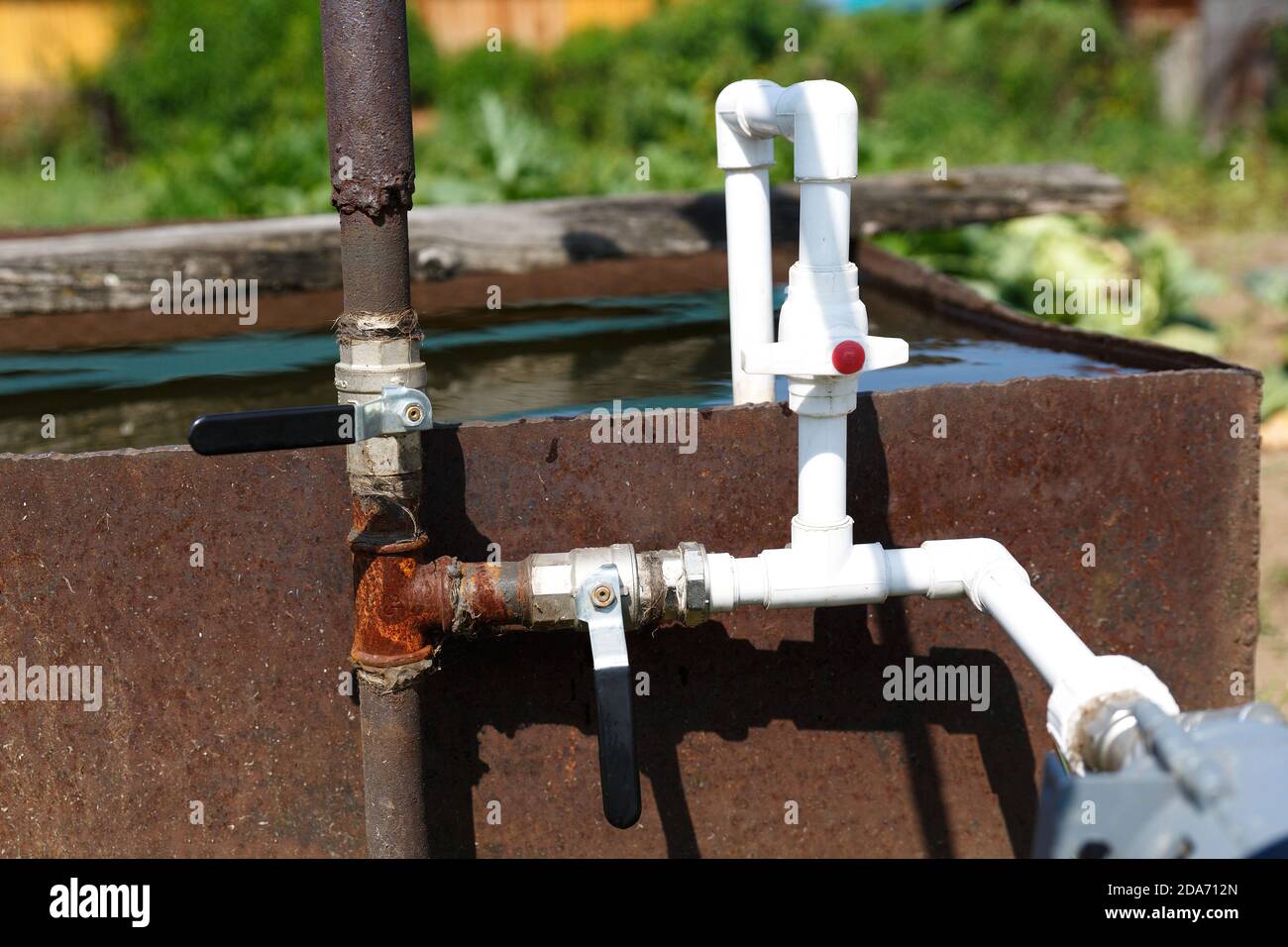 Connection of plastic pipes to the pump and water storage tank. Pumping