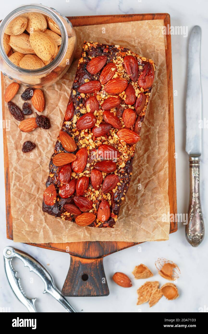 English dried fruitcake. Homemade holiday pie with nuts almonds, fruits raisins and spices. Traditional festive pastries. Christmas. New year. Selecti Stock Photo