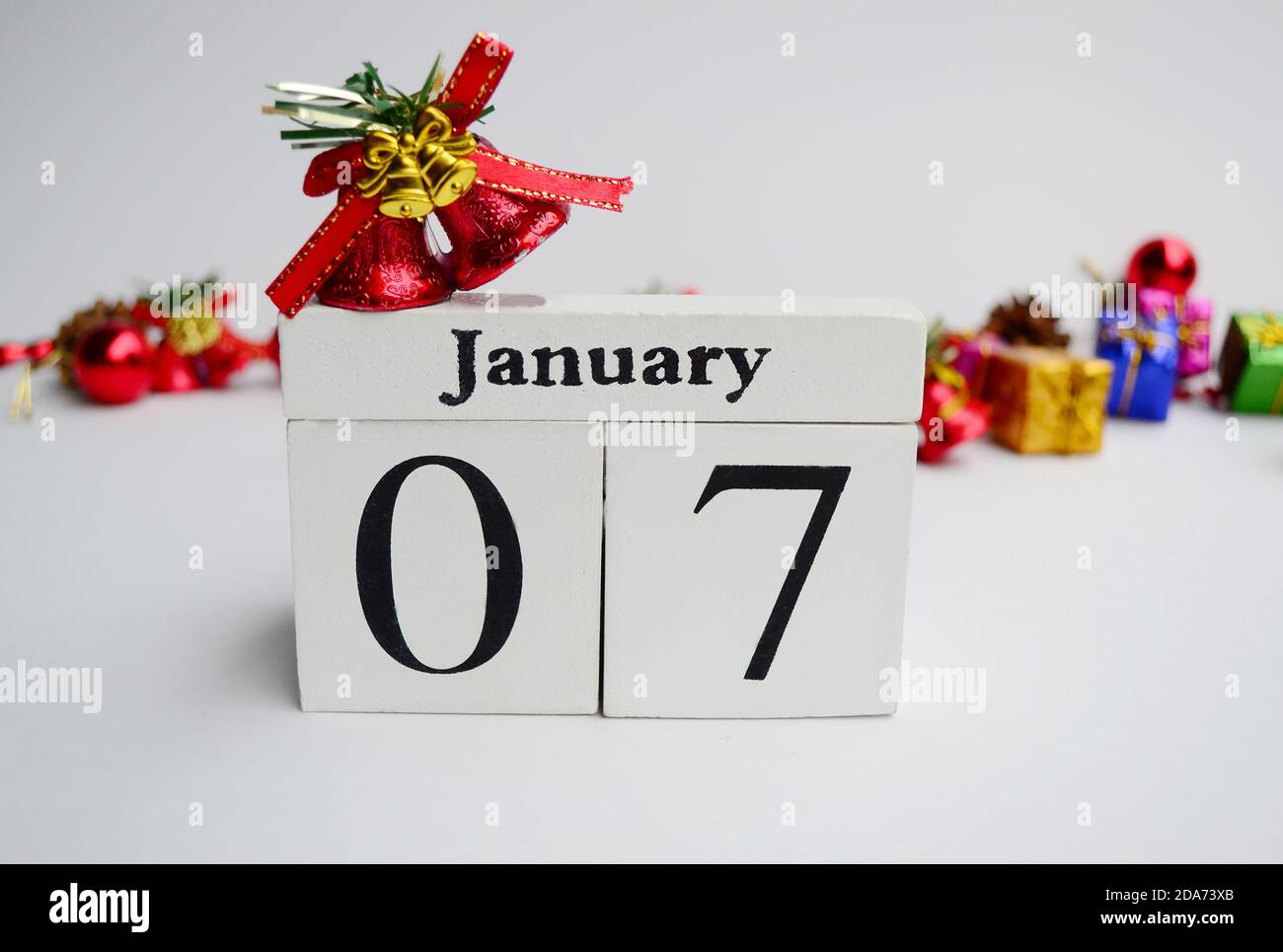 Date 7th January with blurred christmas ornament background Stock