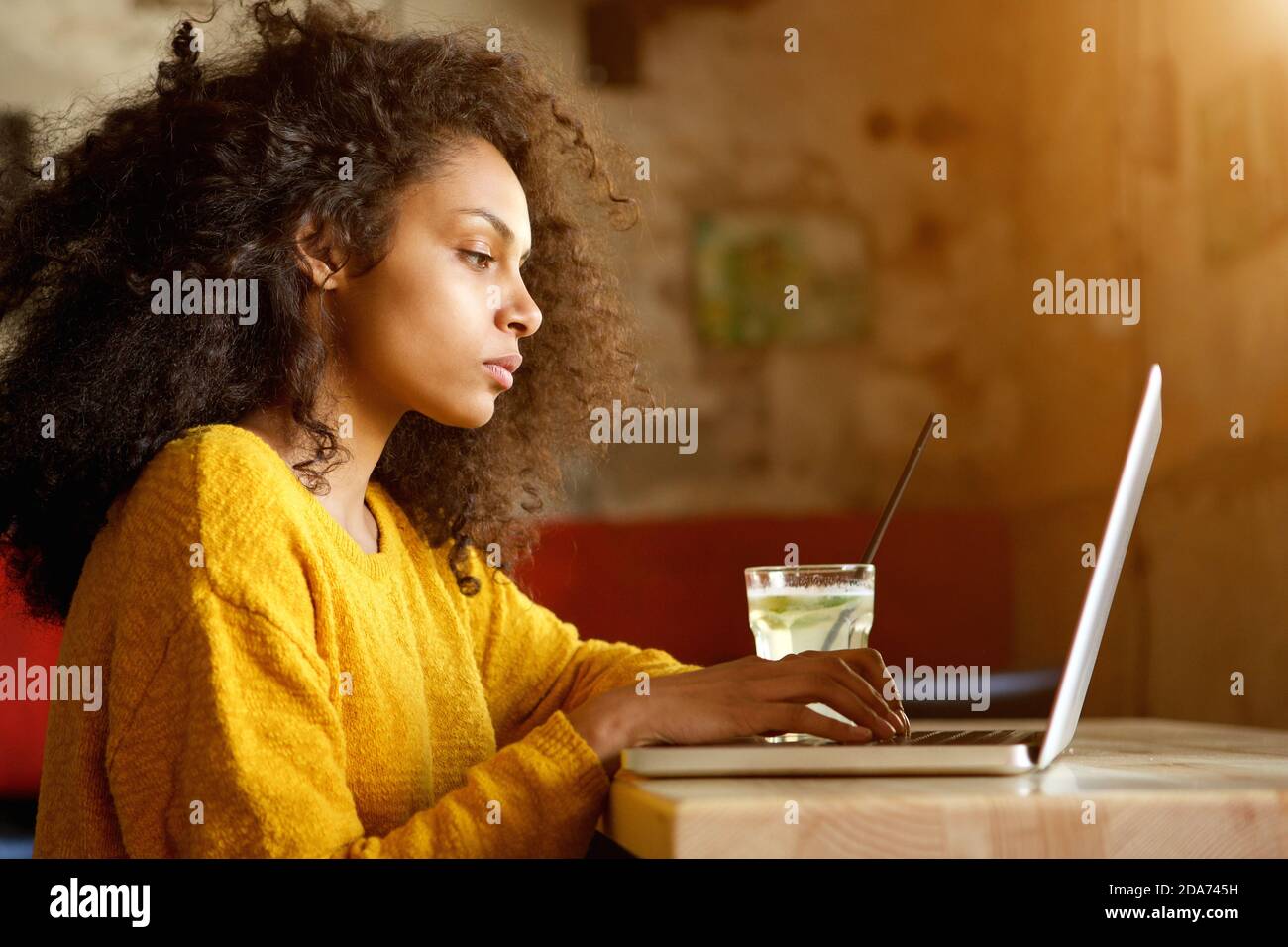 African woman sitting alone side view hi-res stock photography and ...