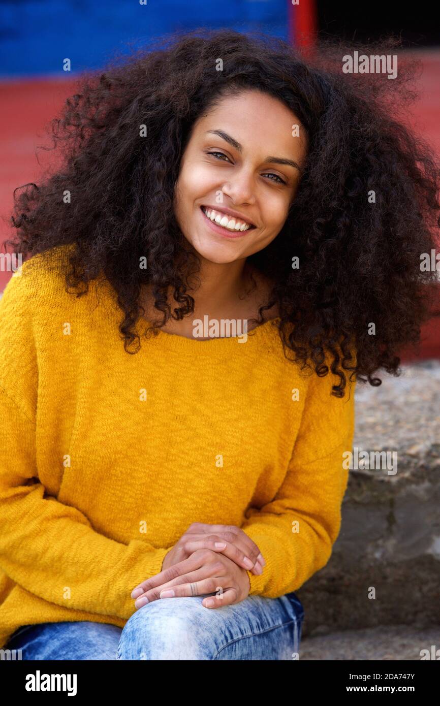 Close up portrait of beautiful young african lady with curly hair ...