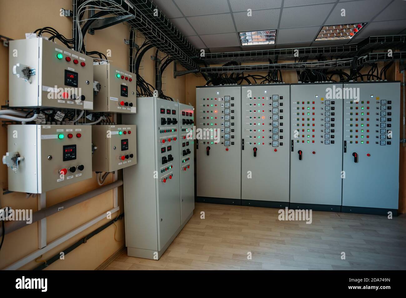 Electrical switchgear cabinets with control panels with indicator lights in factory Stock Photo