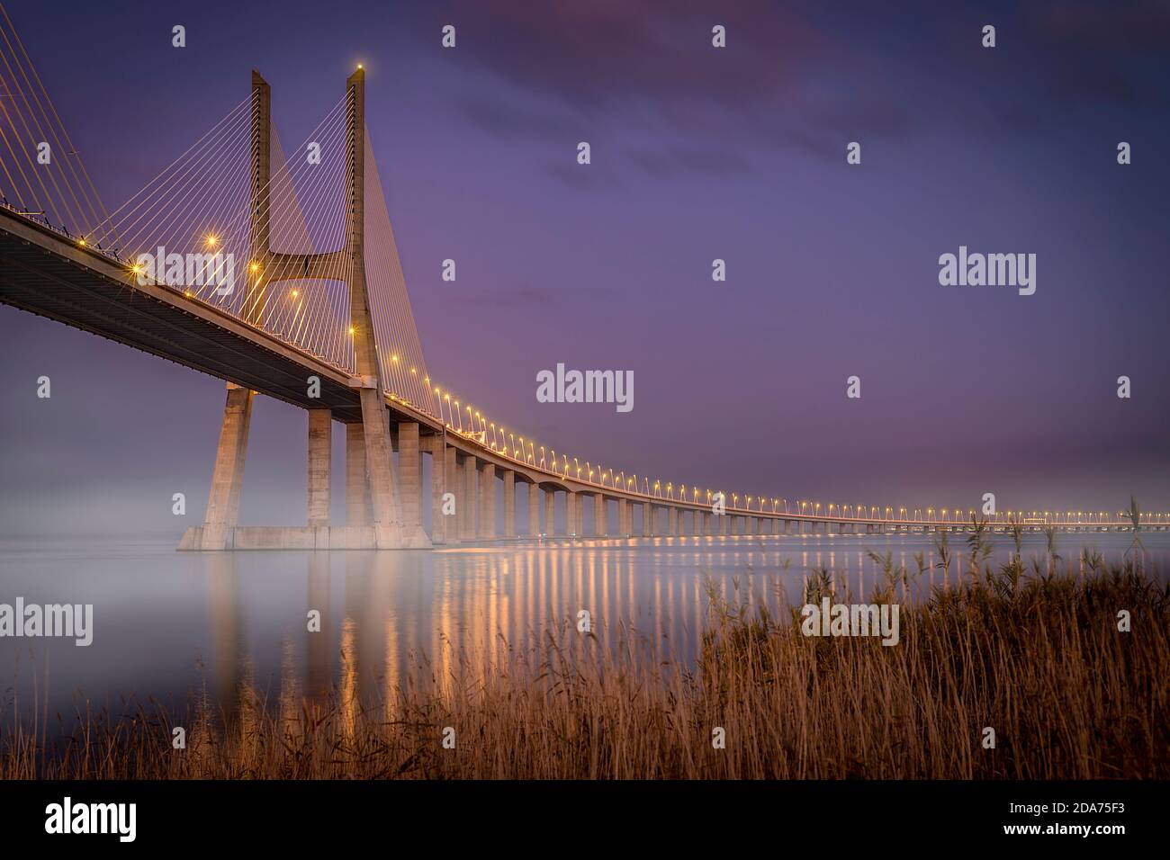 Vasco de Gama bridge at sunset with the lights on Stock Photo