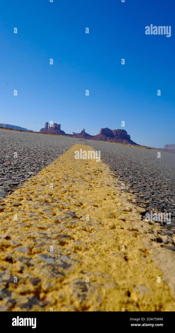 Worm's eye view of Highway 163 with yellow line, Utah Stock Photo