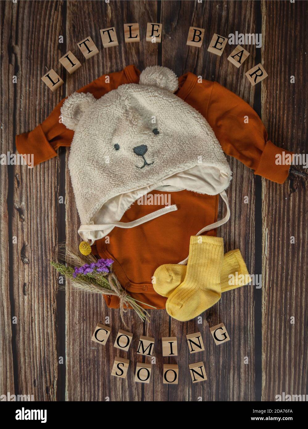 Little Bear Coming Soon. Baby announcement composition on a rustic wooden background. Rustic baby Coming Soon concept. Stock Photo