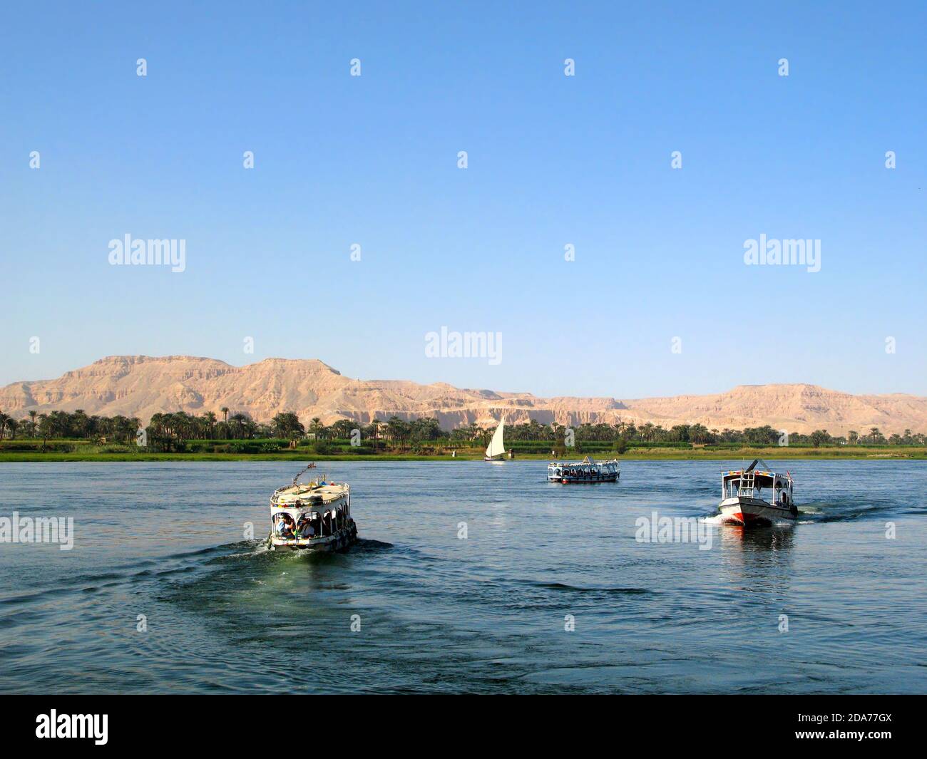 Egyptian boats with tourists on the river Nile near Luxor, Egypt ...