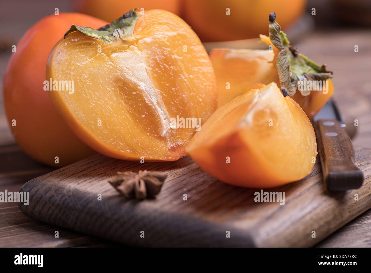 fresh ripe, orange jucy persimmons cut into slices, close-up. Stock Photo