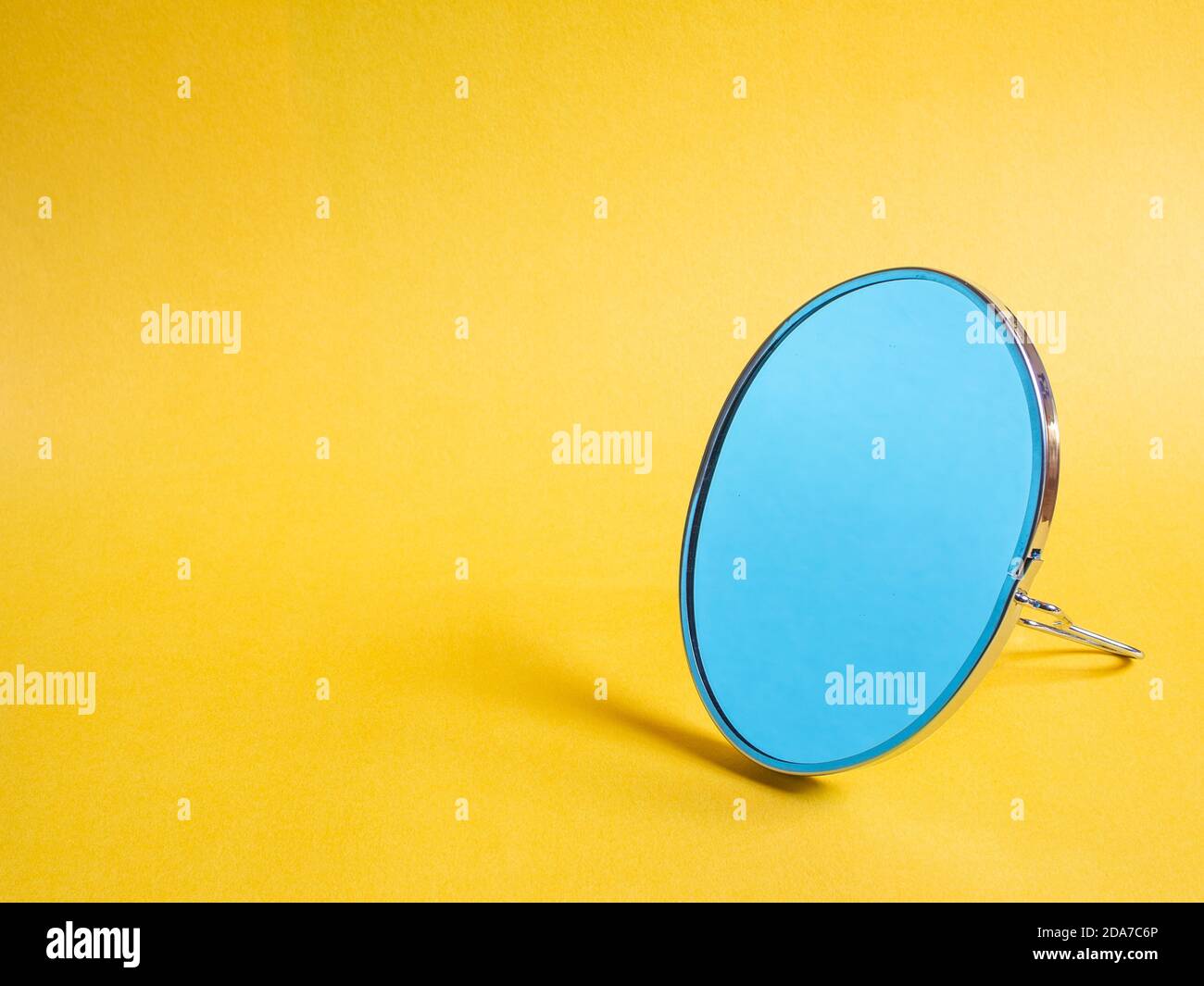 small modern desktop mirror on yellow background Stock Photo