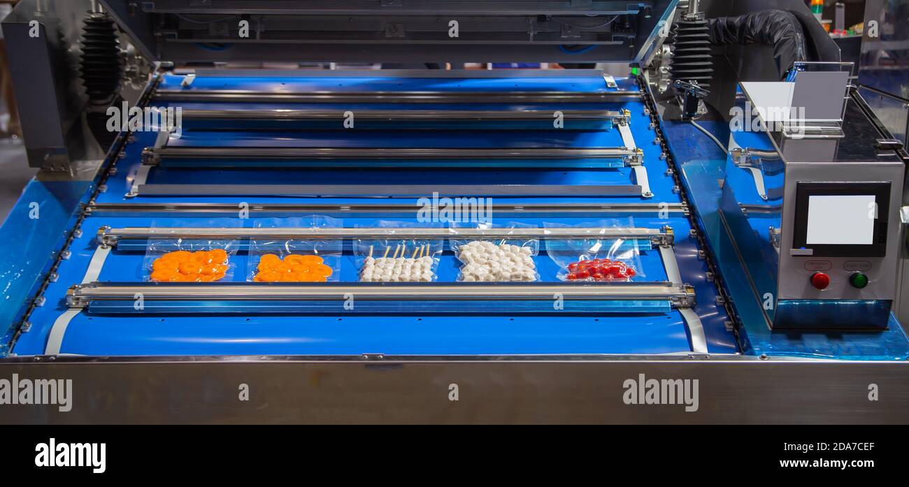 Vacuum heat sealing machine for food package Stock Photo - Alamy