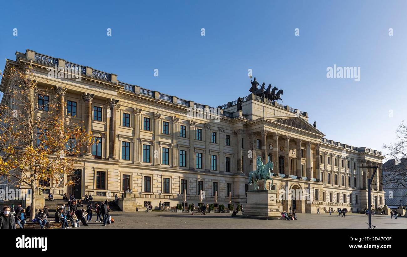 People enjoying sunny day downtown Braunschweig. Schloss-Arkaden shopping mall provides beautiful surrounding and fear of corona virus is not visible. Stock Photo