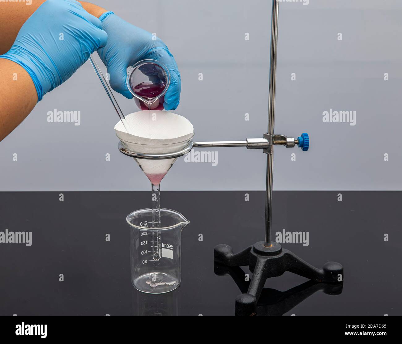 Filter paper in laboratory. Scientists are chemical filtration by filtering  through filter paper in a glass funnel, Close up. Pharmacist filtering sub  Stock Photo - Alamy
