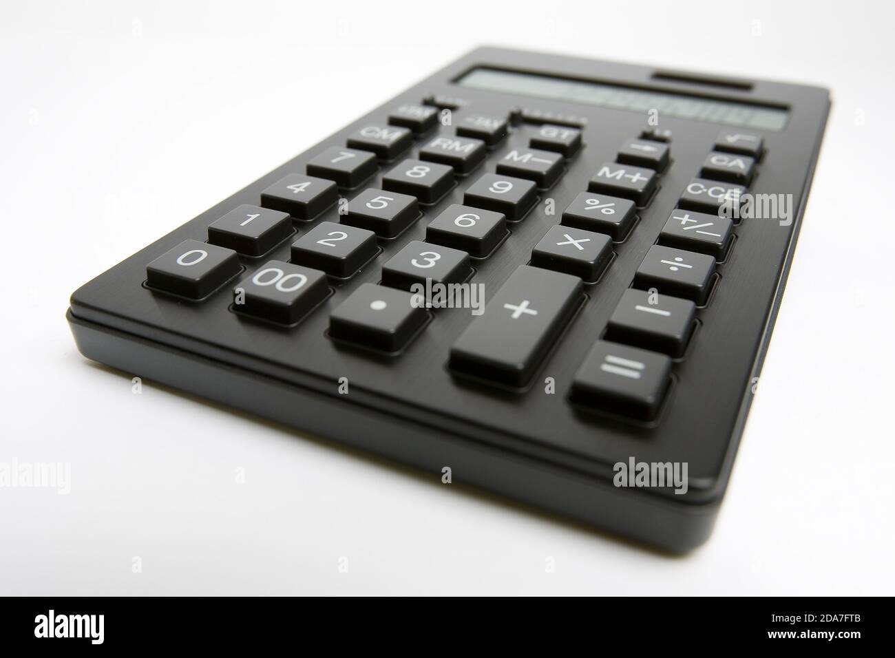 Basic Math Black Calculator Larghe black basic calculator still life shot against a plain white ...