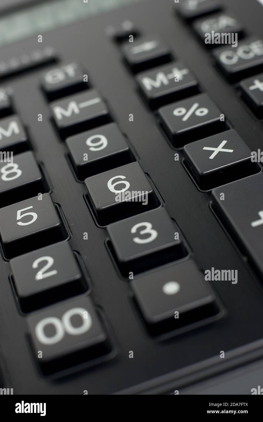 Basic Math Black Calculator Larghe black basic calculator still life shot against a plain white ...