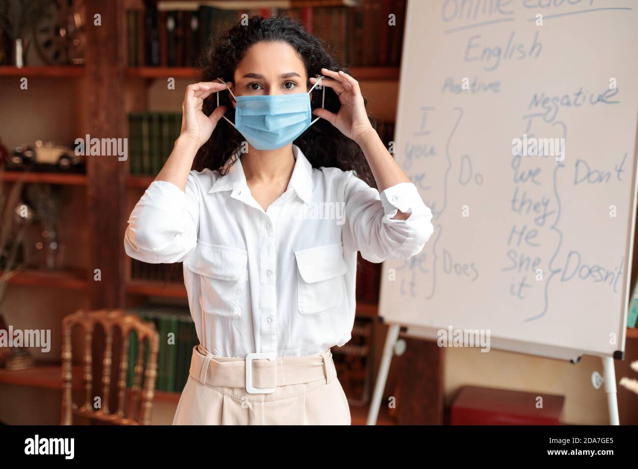 Female teacher wearing face mask at classroom Stock Photo Alamy