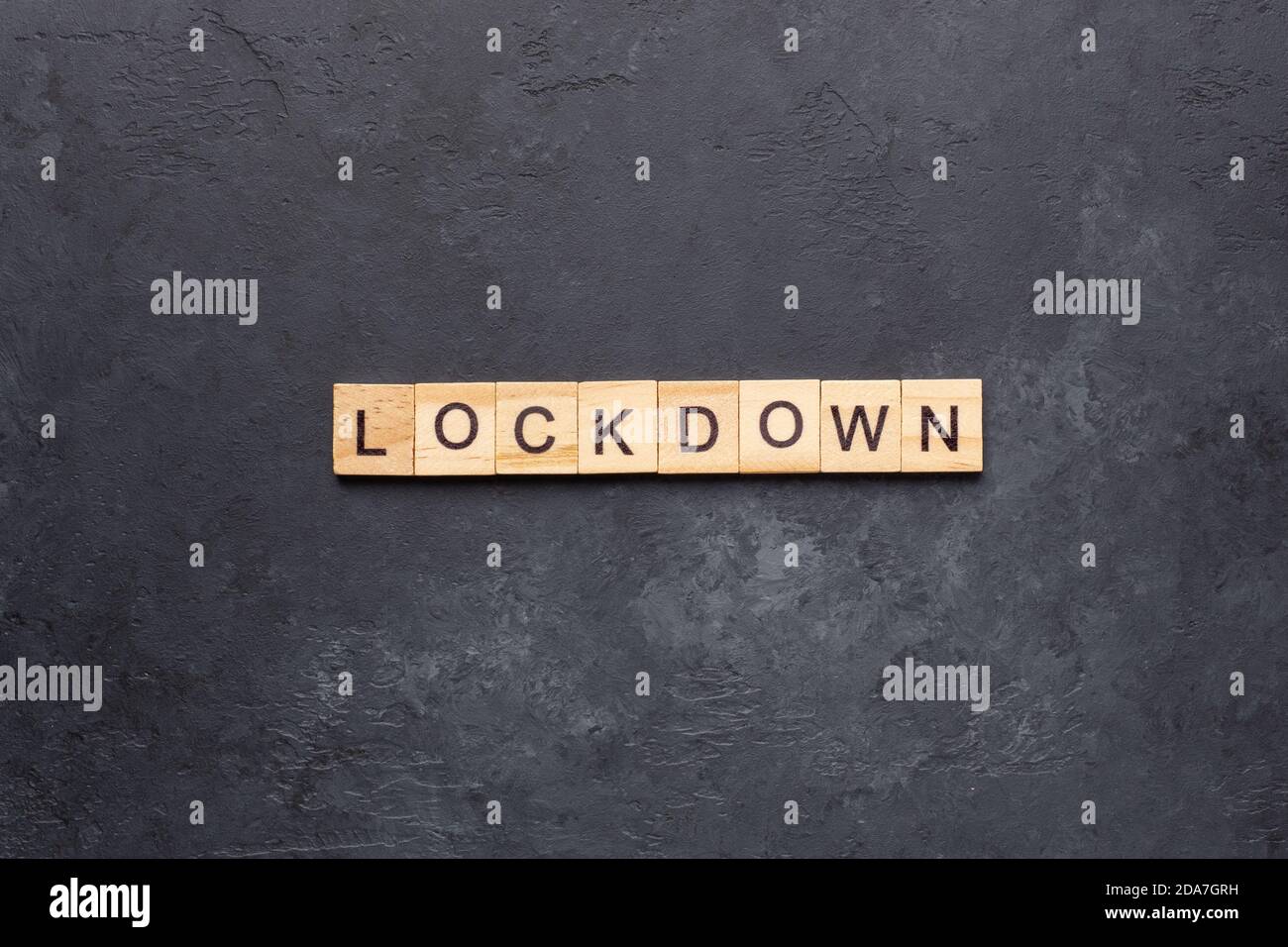 LOCKDOWN text on building blocks on dark stone background - Image Stock ...