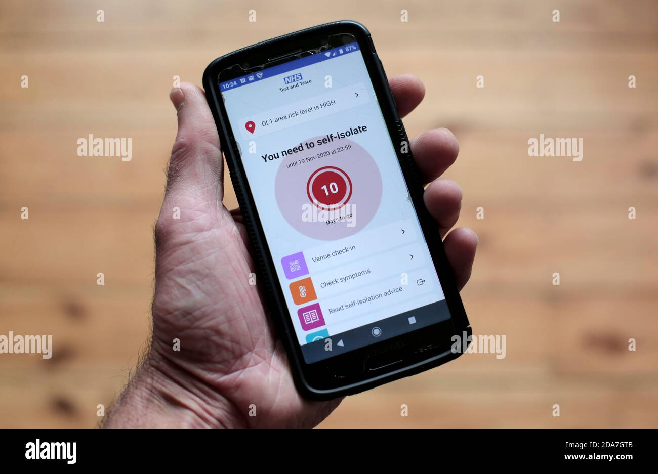 The NHS Test and Trace app flashing up a self-isolate warning on a smartphone. 10/11/2020. Photograph: Stuart Boulton. Stock Photo