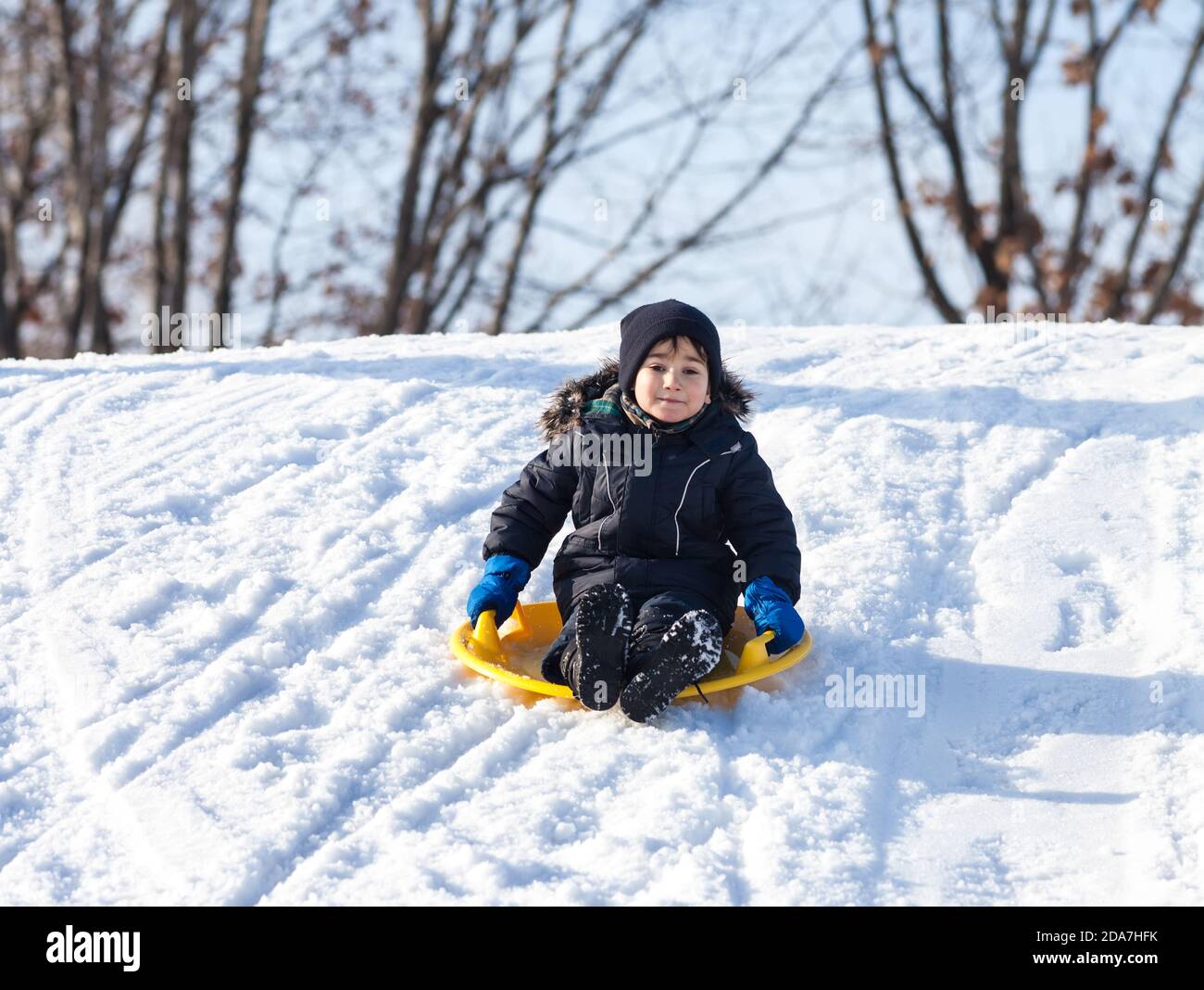 Boy on sleigh. Sledding at winter time Stock Photo Alamy