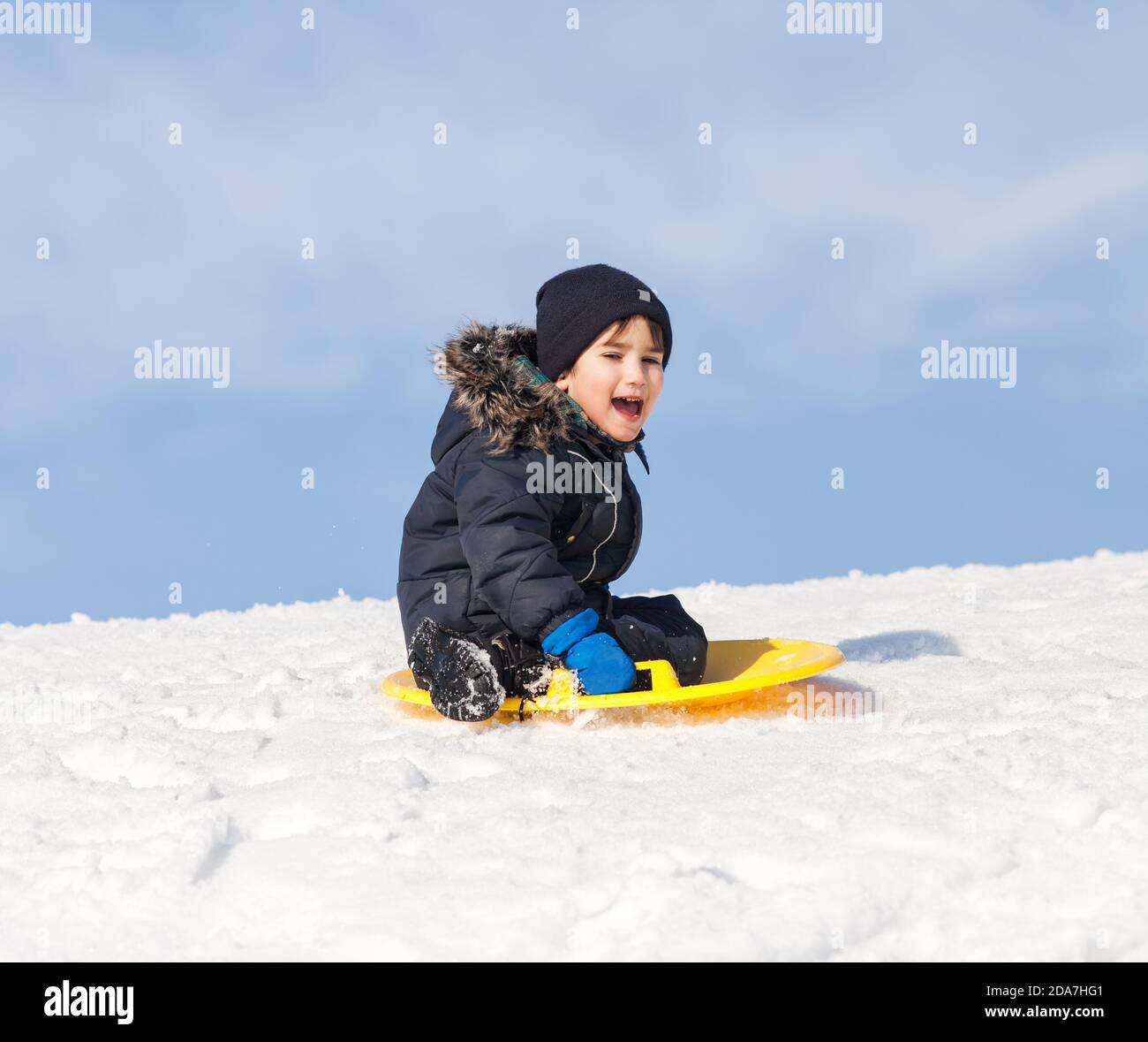 Boy on sleigh. Sledding at winter time Stock Photo Alamy