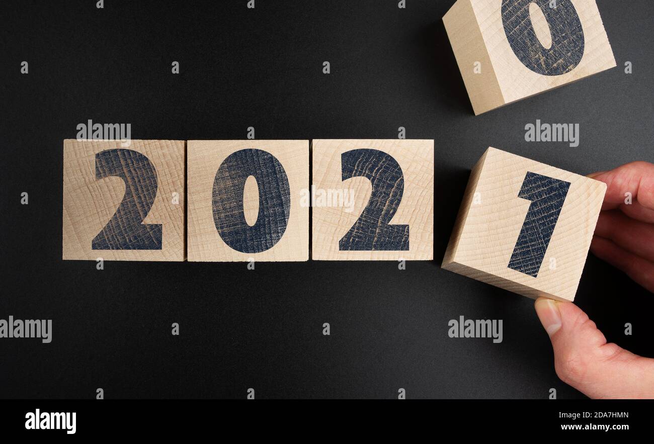 changing 2020 to 2021 on wooden blocks, new year concept Stock Photo