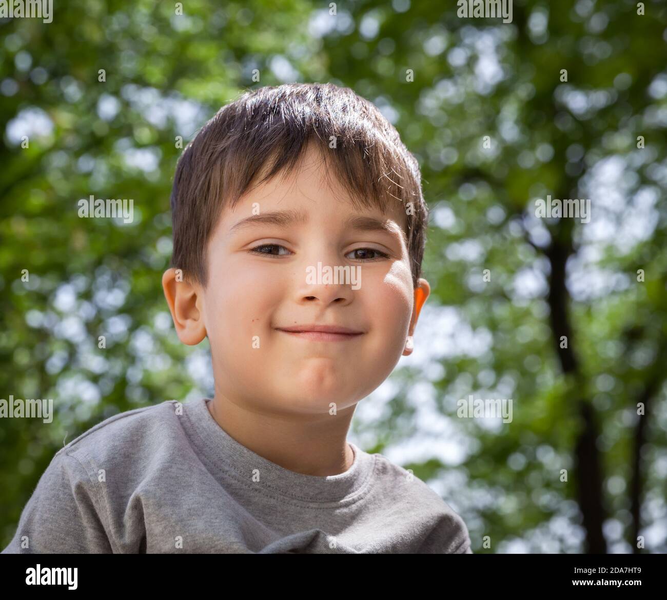 Happy little boy smiling on blurred background Stock Photo - Alamy