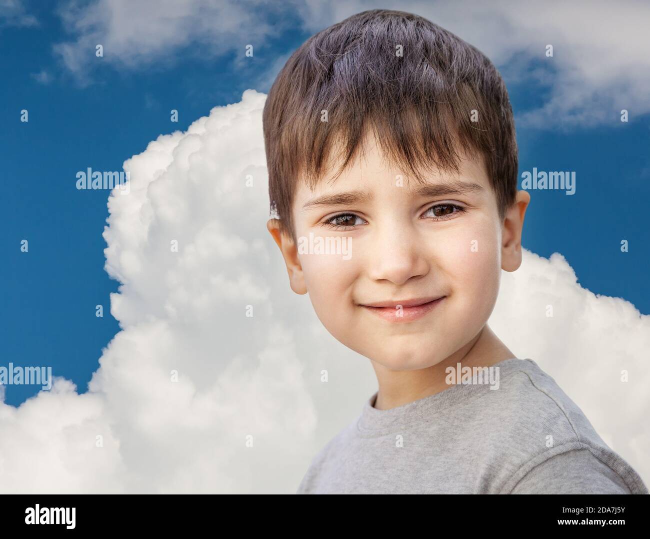 Happy little boy smiling on blue sky with white clouds background Stock ...