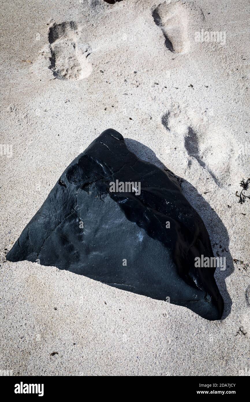 Black rock on a fine sandy beach, Clachtoll, Scotland. Stock Photo