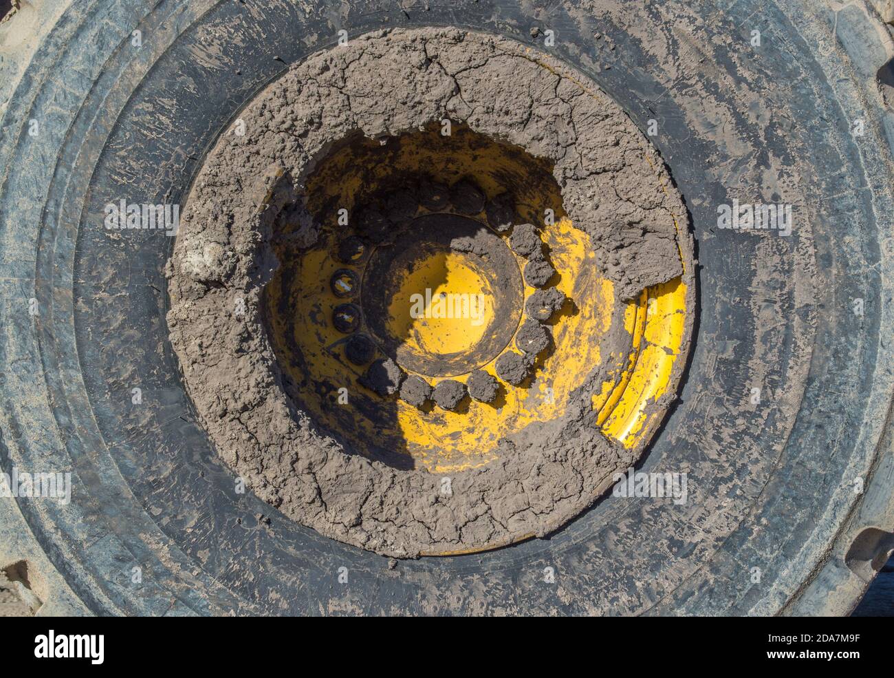 close up of a large heavy duty mud caked bulldozer tire Stock Photo