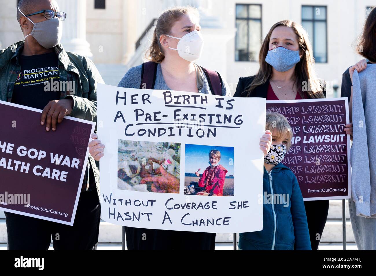 Washington, DC, USA. 10th Nov, 2020. November 10, 2020 - Washington, DC, United States: Woman with a sign saying ''Her birth is a pre-existing condition, without coverage she hasn't a chance'' at a demonstration in front of the Supreme Court in favor of the Affordable Care Act (ACA) on the day that the Supreme Court is hearing arguments in a case regarding it. Credit: Michael Brochstein/ZUMA Wire/Alamy Live News Stock Photo