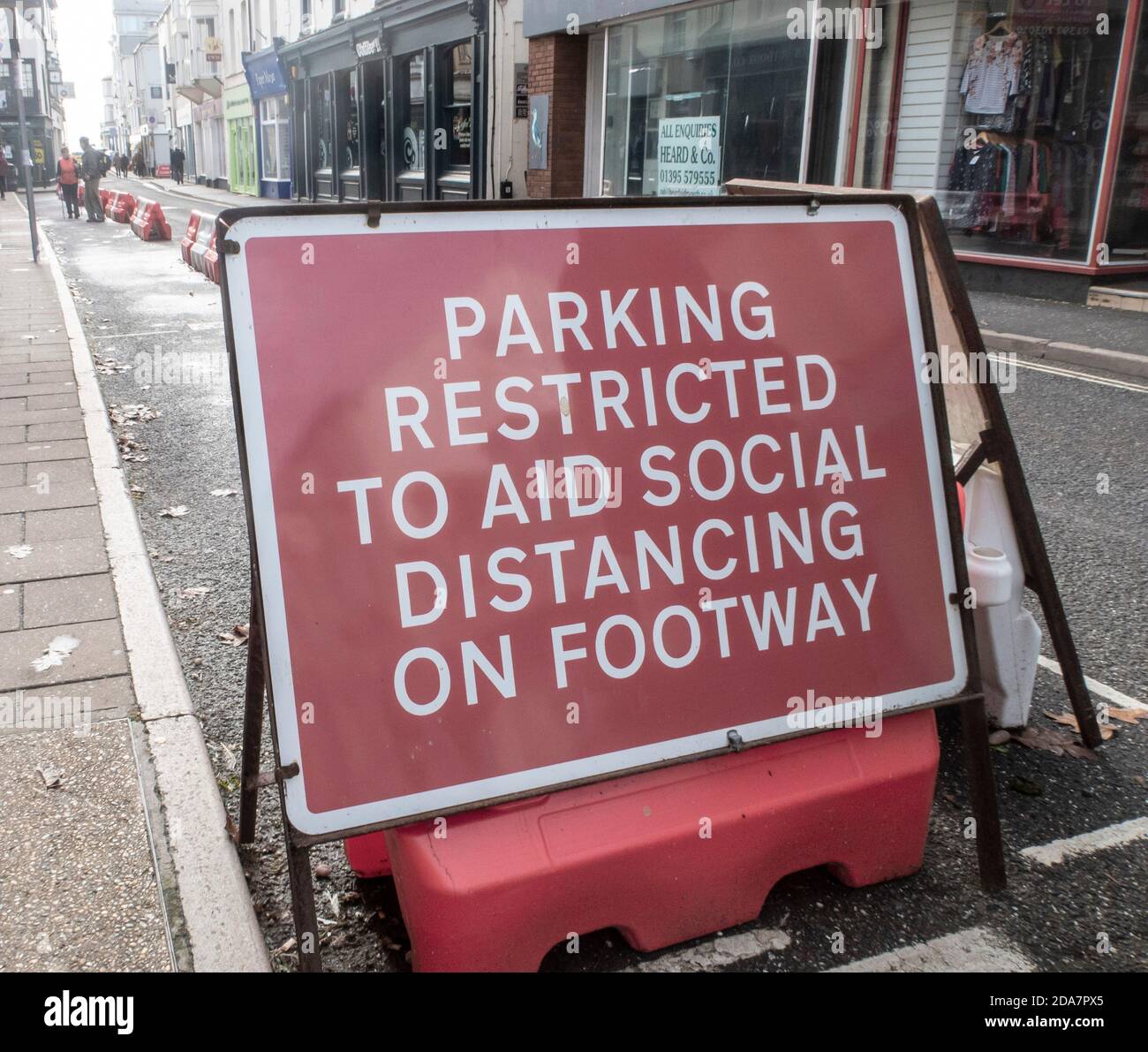 Sign - parking restrictions due to the need for social distancing on the footpath during the Covid 19 coronavirus pandemic. Stock Photo