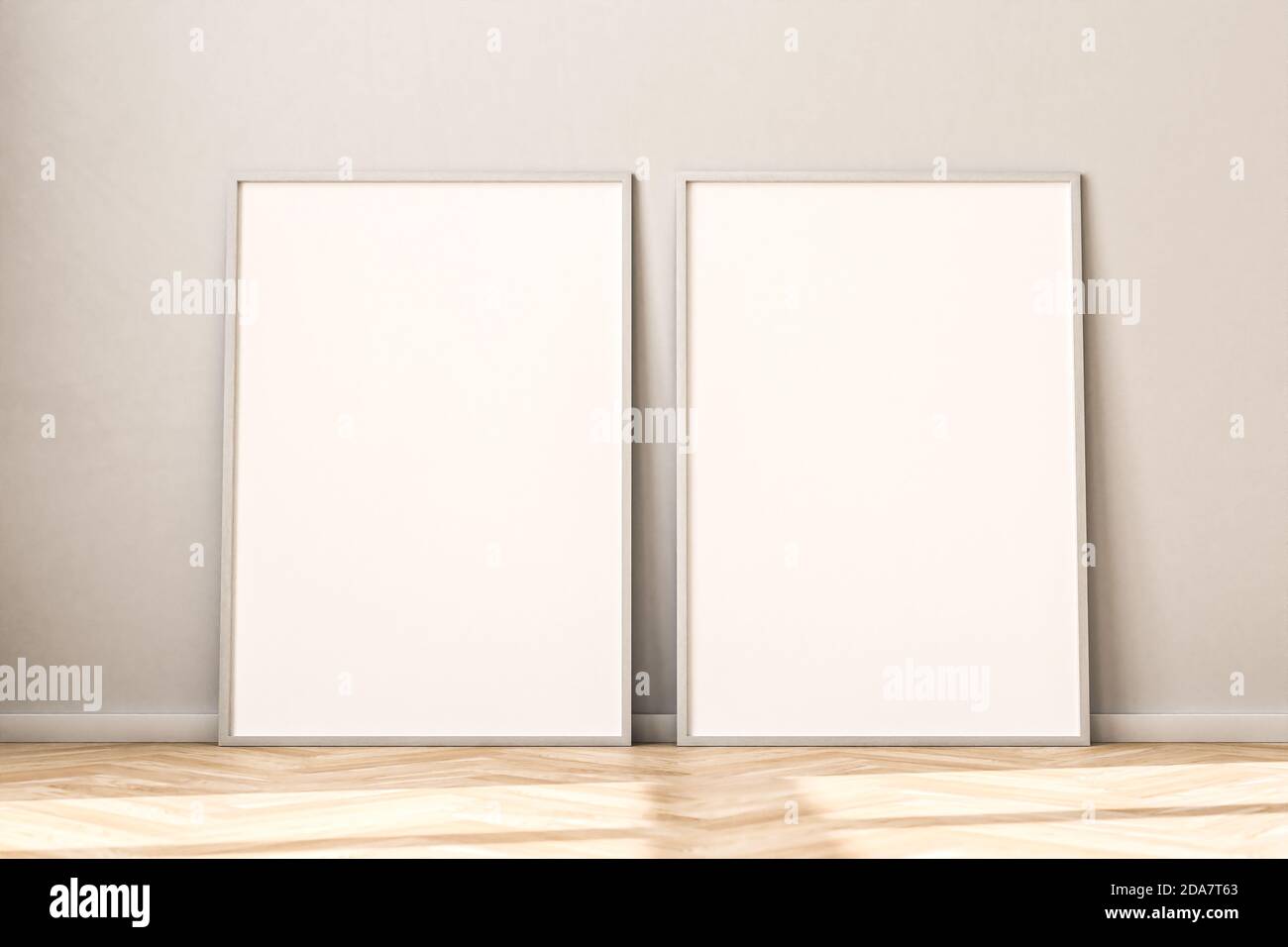 Two empty Picture Frames on parquet floor leaning against bright wall. Sunlight flooding in from the left. 3d render mockup. Stock Photo