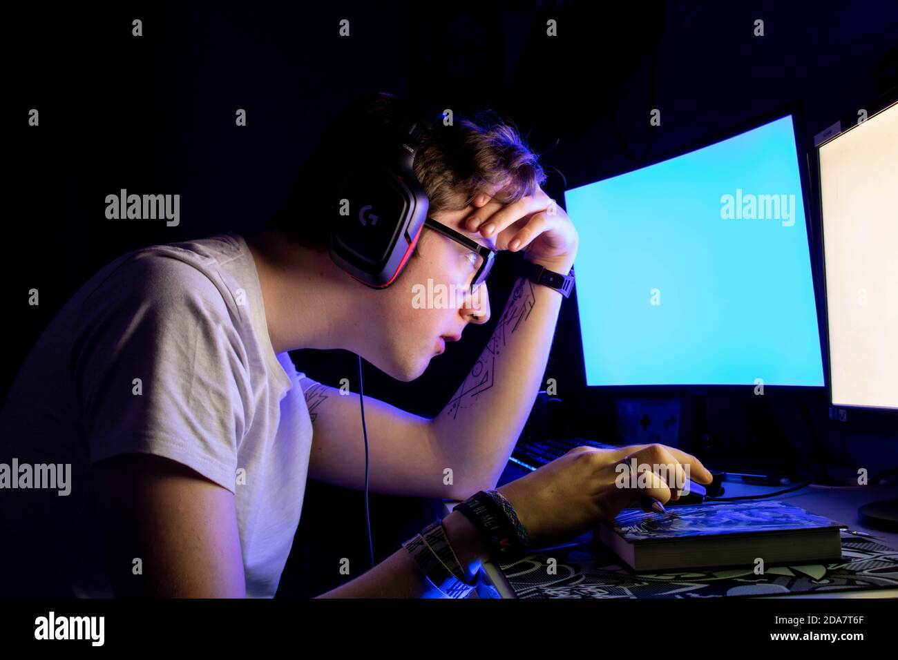 Boy stressed in front of screens Stock Photo - Alamy