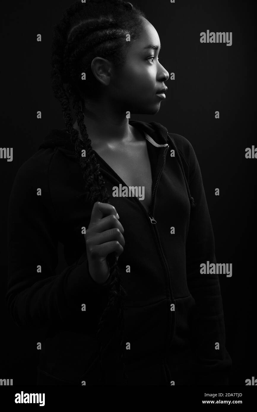 Confident woman with dark skin and cool attitude wearing hoody Stock Photo