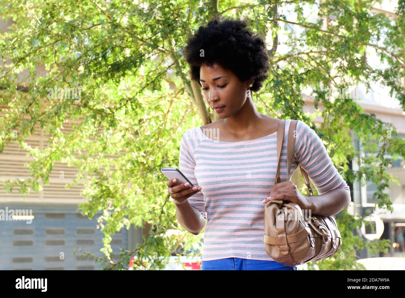 Afro young woman walking using hi-res stock photography and images - Alamy