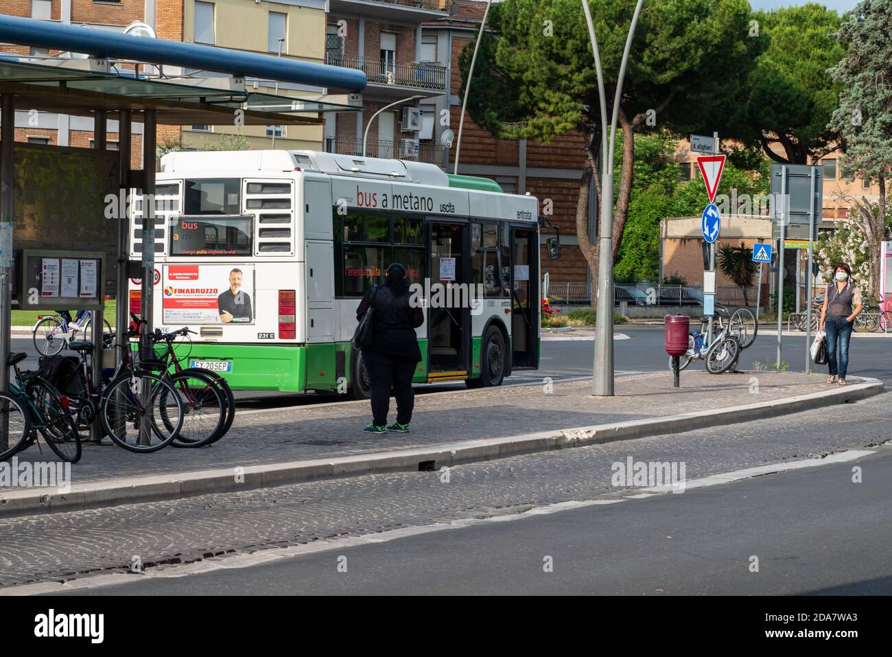 terni,italy may 29 2020:bus at the station and people waiting to leave with masks for covid emergency Stock Photo