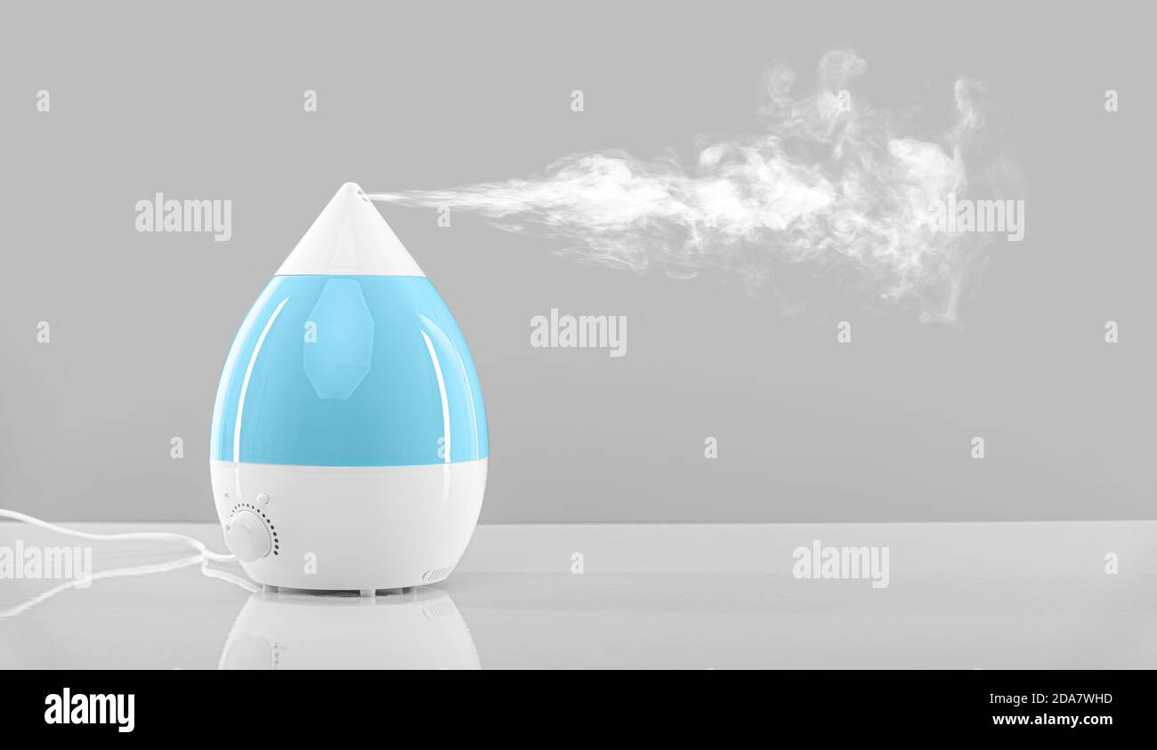 The humidifier releases steam. White humidifier at work Stock Photo Alamy