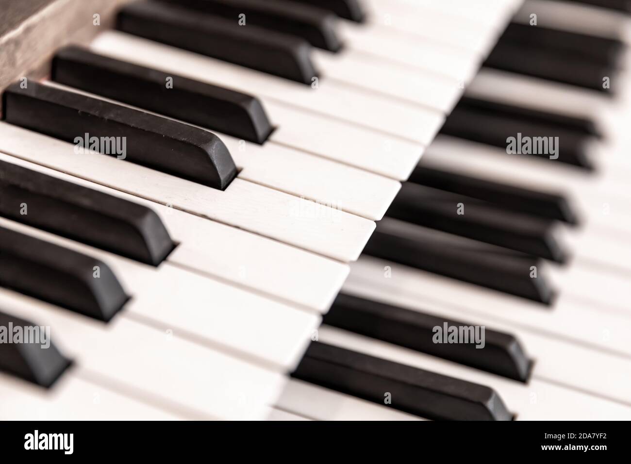 Double layer of keys on a traditional church pipe organ. Retro style with shallow depth of field. Stock Photo