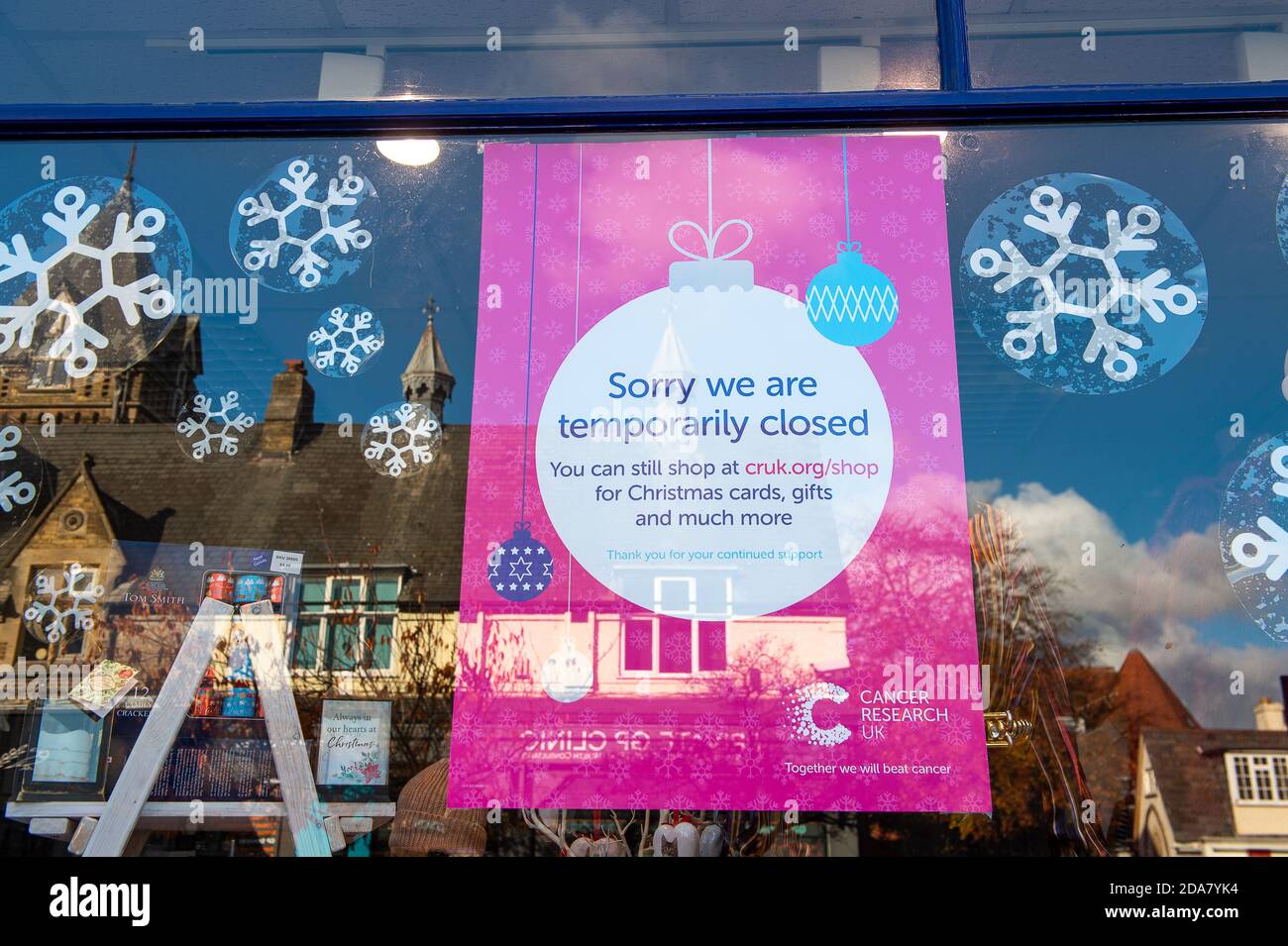 Sunningdale, Berkshire, UK. 10th November, 2020. A sorry we are temporarily closed sign in the Cancer Research UK charity shop during the Covid-19 Coronavirus lockdown 2. Credit: Maureen McLean/Alamy Live News Stock Photo