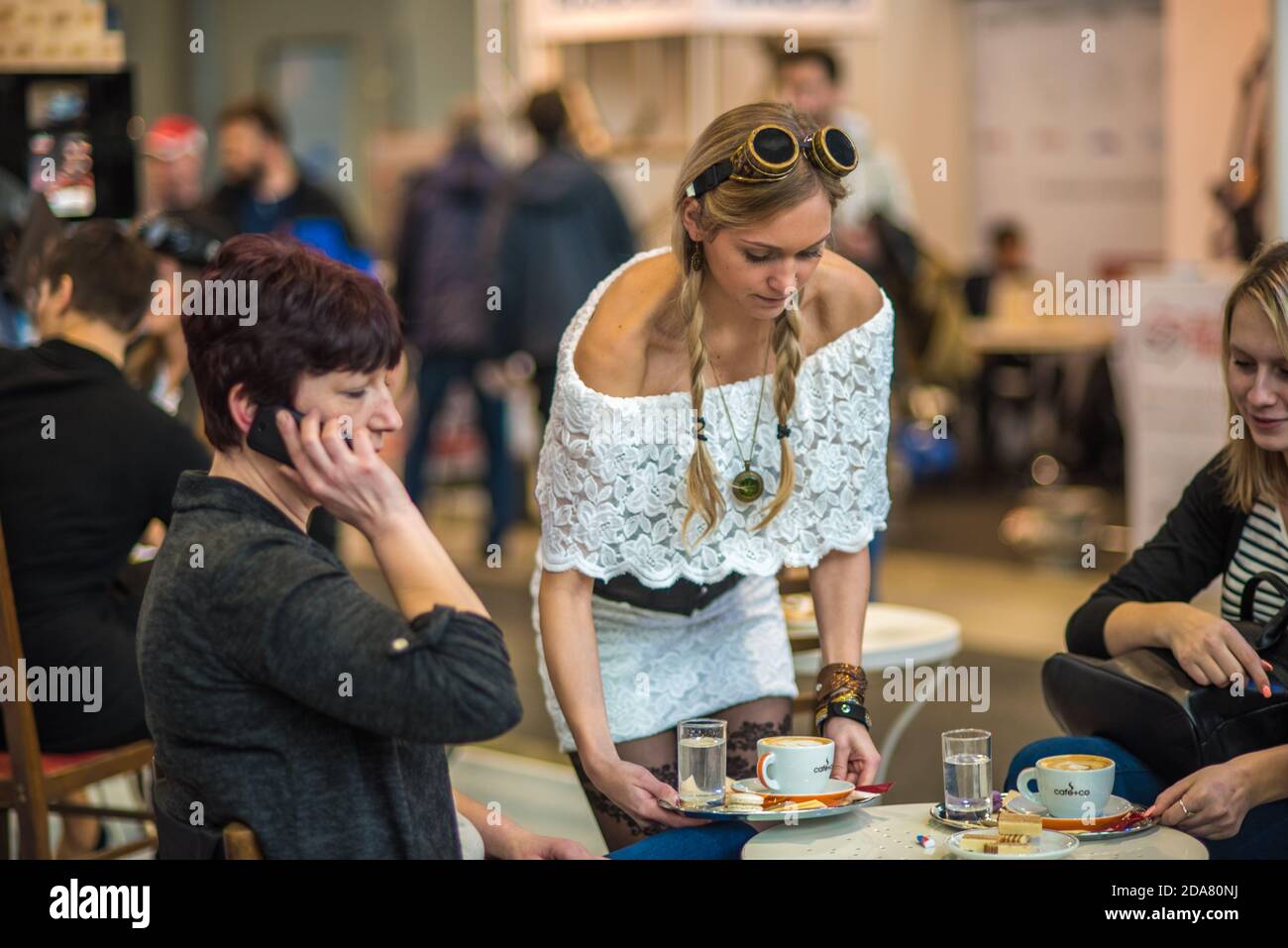 A waitress is serving coffee to a clients at the convention trade center in Brno. BVV Brno Exhibition center. Czech Republic Stock Photo