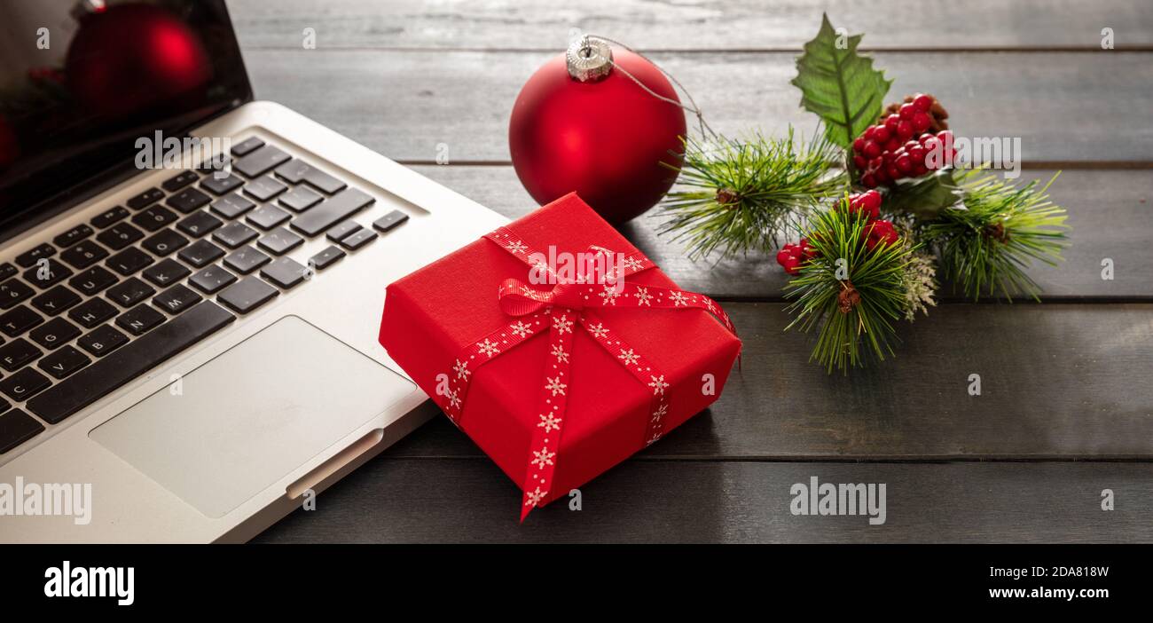 Christmas, office closed. Business desk, computer laptop and xmas decoration on blue wooden background, copy space. Stock Photo