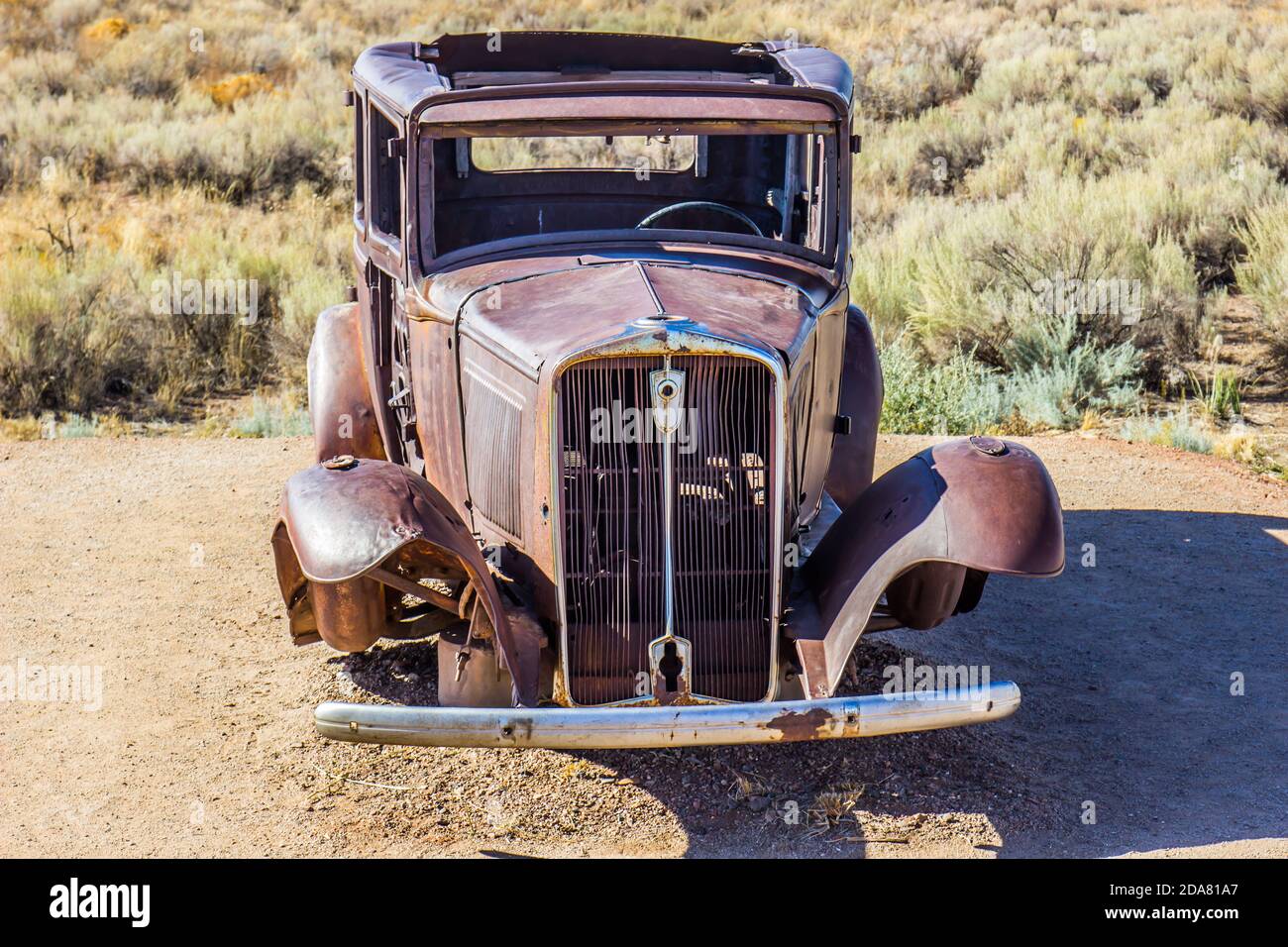 Front Of Abandoned Rusty Retro Automobile In High Desert Stock Photo